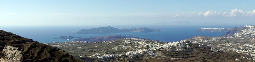 Panoramic view of Santorini island from the top of Mesa Vouno Mountain. - obrazy, fototapety, plakaty