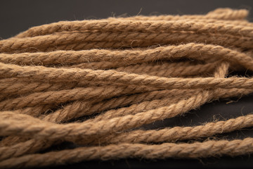 Fototapeta na wymiar brown thick rope, rope on black background