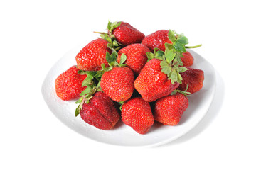 red big strawberries in a white plate on a white background with water drops on berries isolate