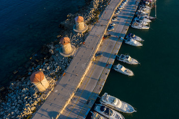 drone view of evening promenade with the famous mills of the port of Mandraki, Greece, Rhodes