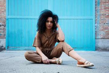  pretty young black woman with afro hair laughing and enjoying