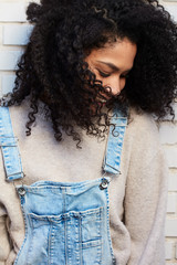  pretty young black woman with afro hair laughing and enjoying