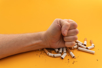 human hand crushed several cigarettes. concept of smoking cessation and healthy lifestyle