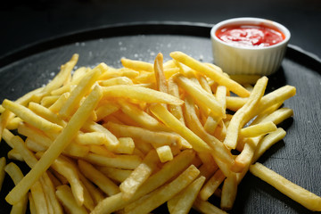 French fries on a dark background, close-up. Fast food.
