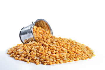 Dry peas and an inverted bucket on a white isolated background. Agriculture.