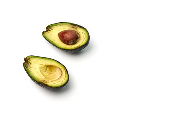 A rotten avocado cut in half on white background. Copy space