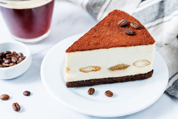 Tiramisu cake decorated with coffee beans with coffee drink