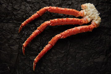Image of fresh crab phalanges on dark background with copyspace