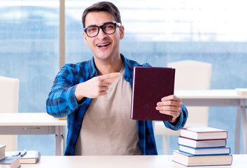 Student studying in the empty library with book preparing for ex