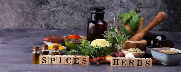 Spices and herbs on table. Food and cuisine ingredients with pepper and spices herbs sign with wooden cubes