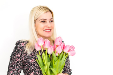 Woman with Spring Flower bouquet. Happy surprised model woman smelling flowers. Mother's Day. Springtime