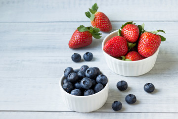 Fresh berries (blueberries and strawberries)  on the table.