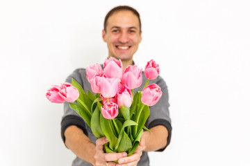 Man holding tulips. Gift card template, poster or greeting card - man holding bouquet of tulips for a woman. Mother's day, Valentine's day, Women's day concept. 8 of March gift