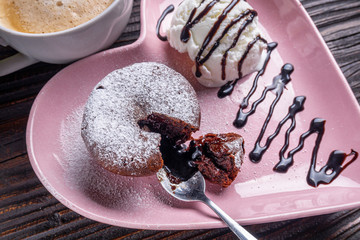 chocolate fondant with ice cream on wooden rustic background