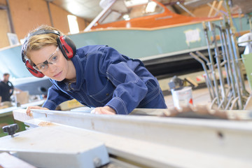 young beautiful woman in overalls and glasses