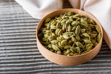 fragrant green cardamom on a wooden rustic background