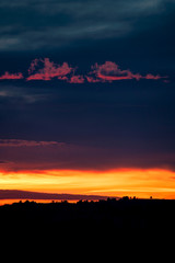 Dramatic sunset clouds over mountain silhouette