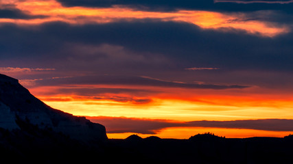 Dramatic sunset clouds over mountain silhouette