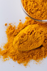 natural turmeric powder on white acrylic background