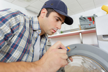 worker is screwing a washer