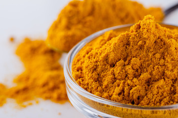 natural turmeric powder on white acrylic background