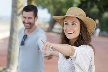happy tourists pointing at something