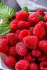 juicy fresh natural raspberries on a dark wooden rustic background