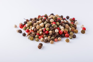 mix of peppercorns on white acrylic background