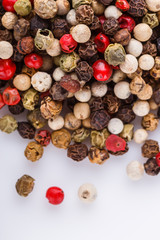 mix of peppercorns on white acrylic background