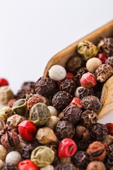 mix of peppercorns on white acrylic background