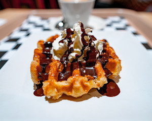 coffee with milk and waffle with chocolate and cream