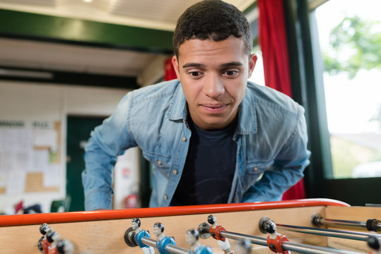 young man playing table football