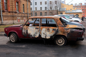 old car after a fire parked in a parking lot