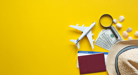 Travel accessories and objects on a yellow background with a top view and copy space. Airplane and...