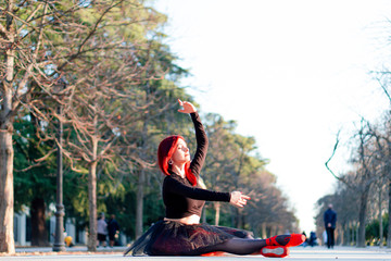 Redhead dancer dancing ballet in the Retiro park in Madrid