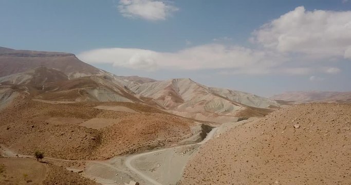 mountain view in zagros range in iran with blue sky and clouds road and valley