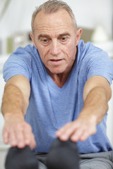 Fototapeta premium senior man doing recovery excersises at home
