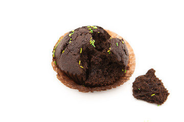 Chocolate cupcake with colored decorative sugar sprinkles isolated on white background