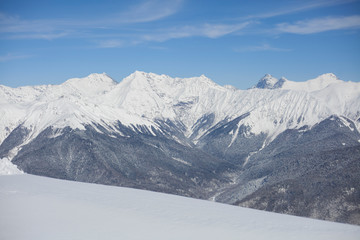 Obraz premium Mountain landscape with snow. Snow-capped peaks of the mountains. High altitude. Background of calm mountains. Sunny weather in the highlands.