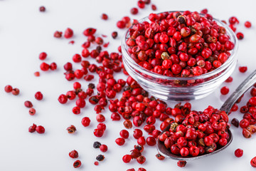fragrant pink peppercorns on white acrylic background