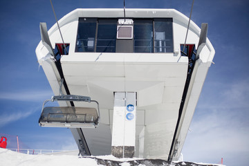 The main unit of the electric cable car. Support post on the ski lift. Sophisticated design aimed at holding metal tross. Hillside equipment for skiing.
