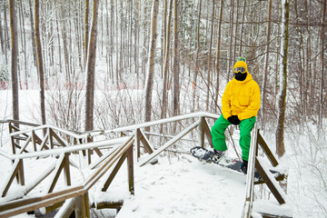 bright guy in a yellow jacket on a snowboard.winter holiday