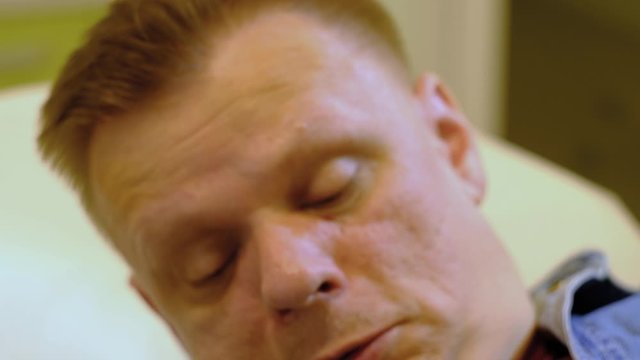 a man lies and prepares for a medical procedure