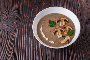 mushroom cream soup on rustic wooden background