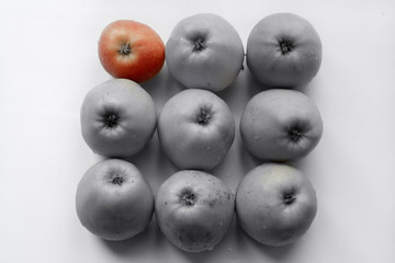 not like everyone else - one apple is knocked out of the general picture of a regular square consisting of apples