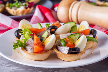 delicious snack tartlets on dark stone background
