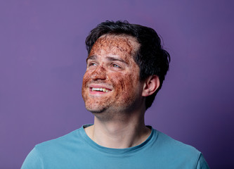 Fototapeta premium smiling guy in a face care mask