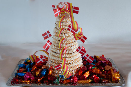 Traditional Scandinavian tower cake (kransekake) made from baked marzipan, decorated with icing