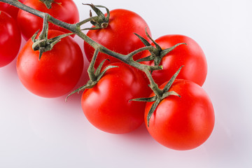 juicy fresh cherry tomatoes on a white background