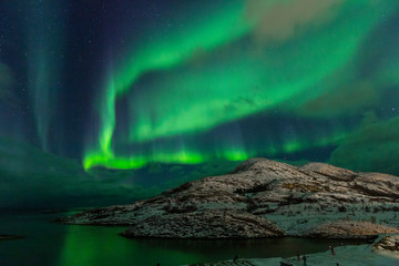 Fototapeta na wymiar Northern lights on the arctic sky. Hillesoya, Sommaroya.